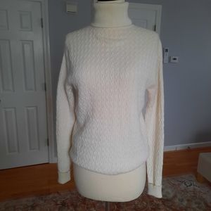 Cable knit cashmere cream turtelneck sweater.